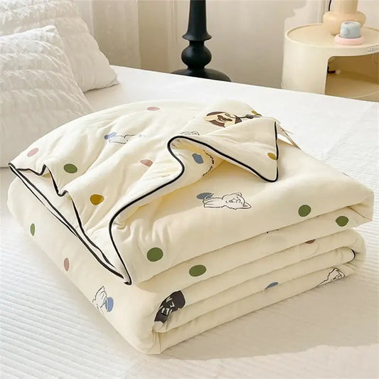 Cream-colored kids summer quilt with playful cartoon animal prints and multicolored polka dots by decorbites kids summer