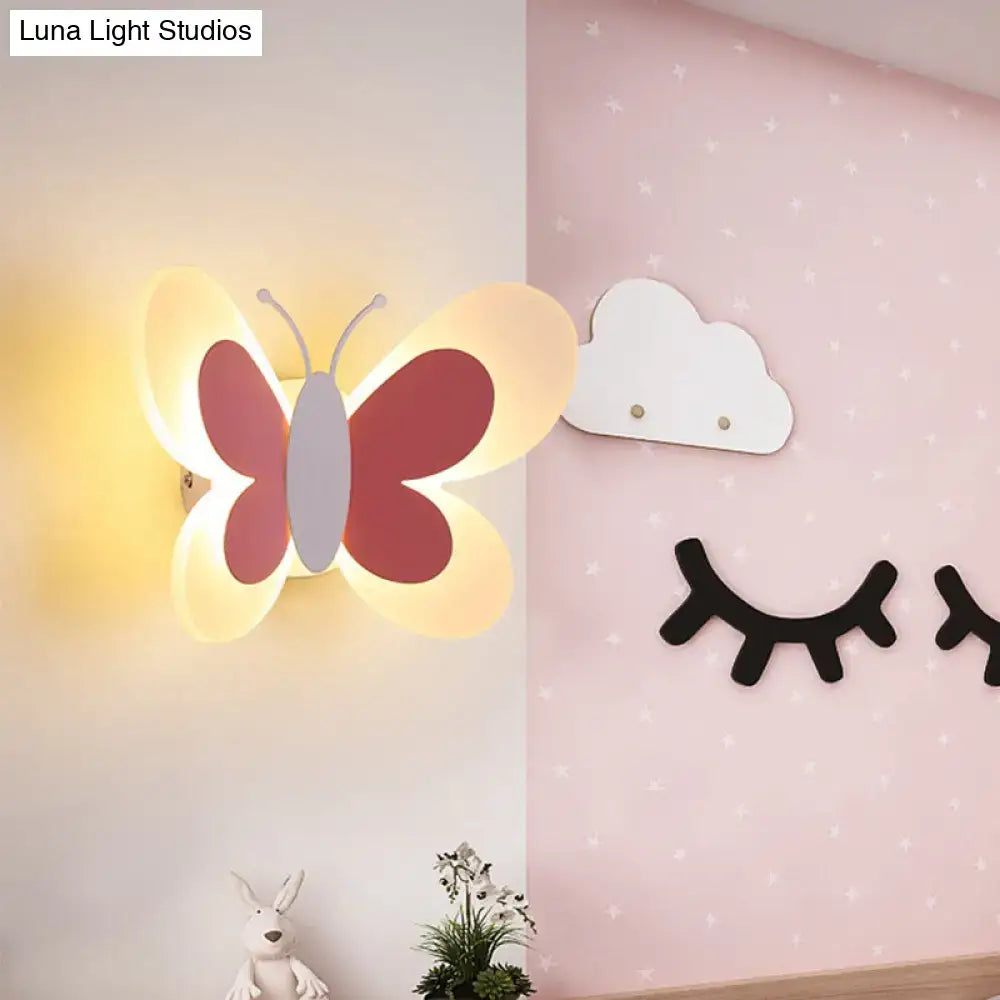 A warm glowing butterfly-shaped led wall sconce with red and cream wings for kindergarten decoration