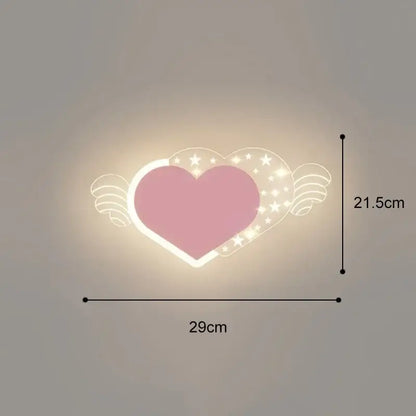Pink heart-shaped wall lamp with angel wings and star details emitting warm glow in cartoon wall lamp style