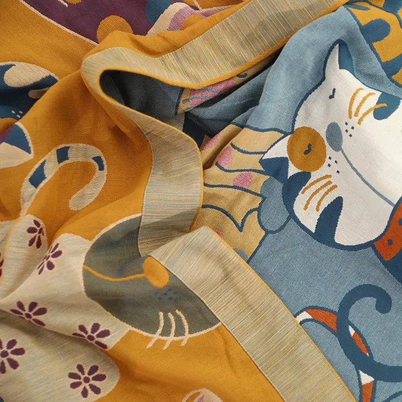 A decorbites cartoon boho soft cotton blanket featuring vibrant yellow and blue cartoon cat embroidery for bedroom decor