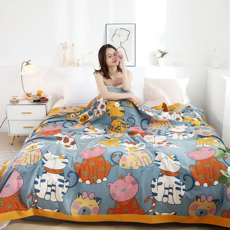 Cozy blue woven cotton cartoon boho bedspread with colorful cat patterns and floral accents by decorbites cartoon