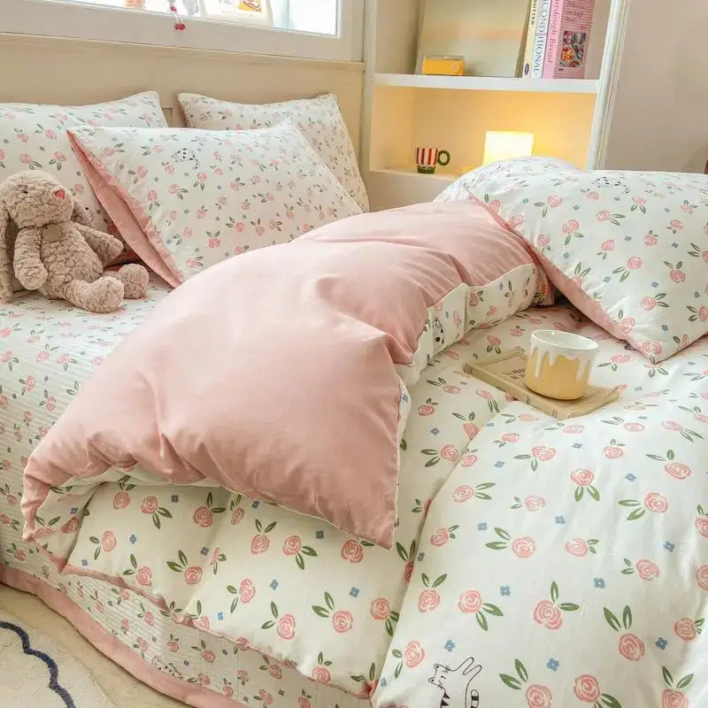 Pink floral-patterned cotton duvet set featuring delicate rose motifs and cartoon cat floral design for bedroom bedding
