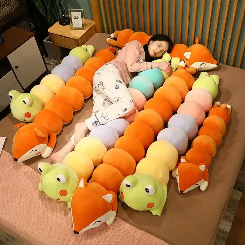 Cartoon caterpillar long body pillow featuring colorful orange fox and green frog plush segments for bedroom use
