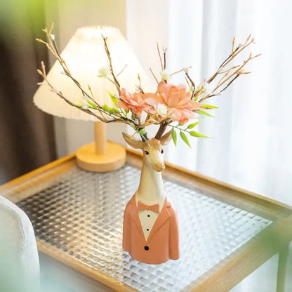 A ceramic cartoon deer vase in beige and orange resin with peach and white blossoms for living room decor
