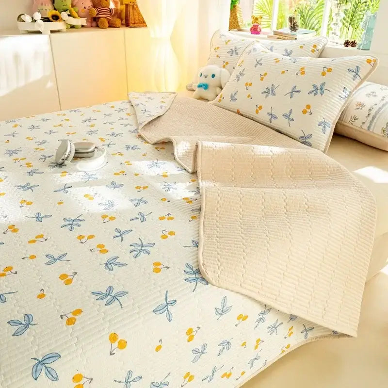 Cream-colored quilted cotton bed cover set with blue dragonflies and yellow cherries on off-white background