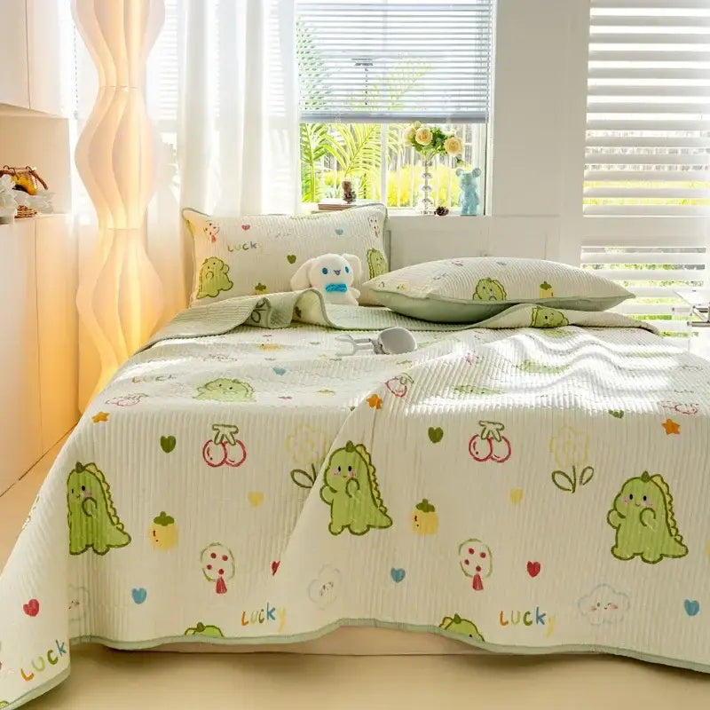 Cute green dinosaur-themed quilted bed cover set with soft ribbed cotton texture and playful cherry and heart patterns