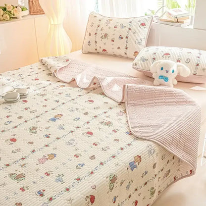 Cream-colored quilted cotton bed cover set with pastel cartoon characters and floral pattern for bedroom use