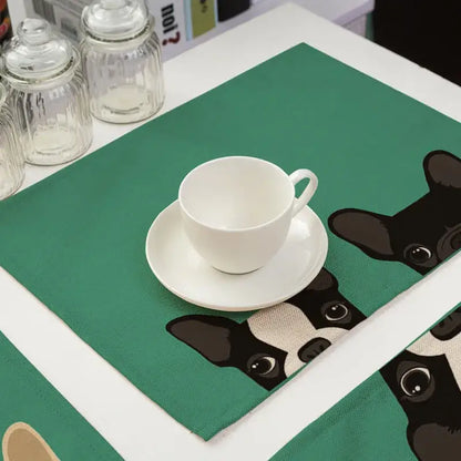 White ceramic coffee cup on green cotton linen dining table mats with black and white boston terrier illustrations