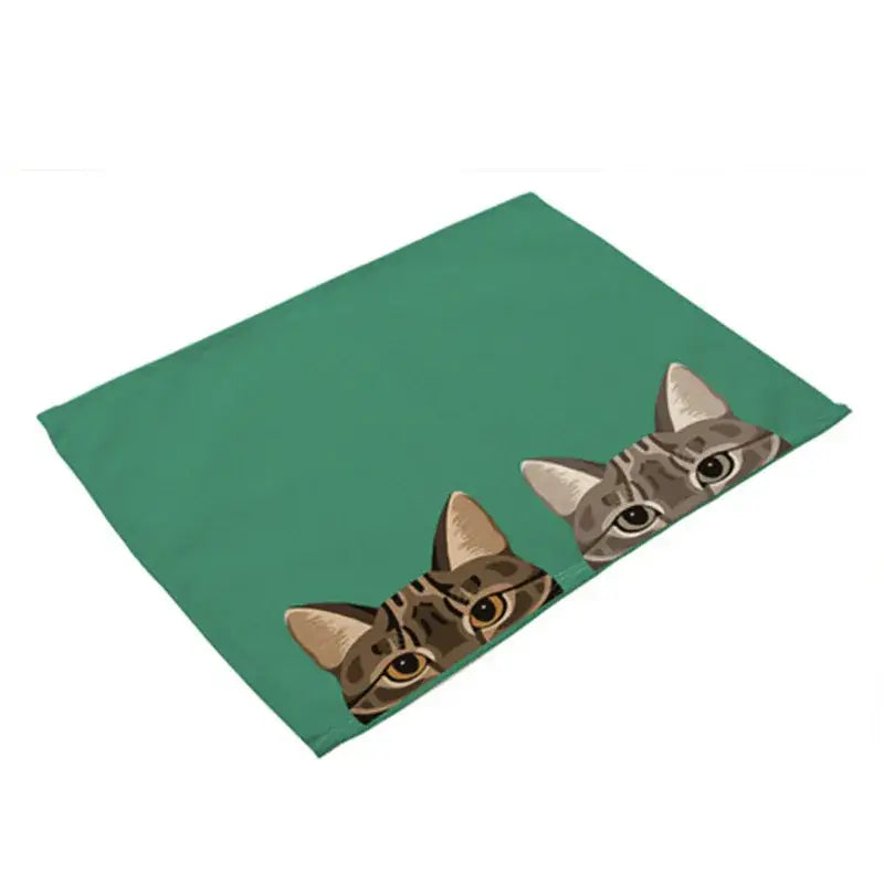 Green cotton linen rectangular dining table mats featuring cartoon tabby cats peeking over the edge set of 4
