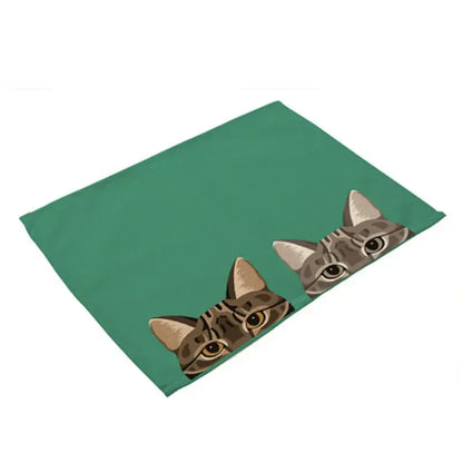 Green cotton linen rectangular dining table mats featuring cartoon tabby cats peeking over the edge set of 4