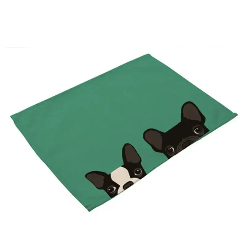 Teal cotton linen dining table mats featuring a cartoon illustration of two french bulldogs peeking over the edge