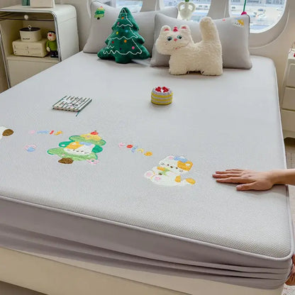 Light gray textured mattress pad with decorbites cartoon embroidered playful cat and christmas tree appliqués fitted sheet