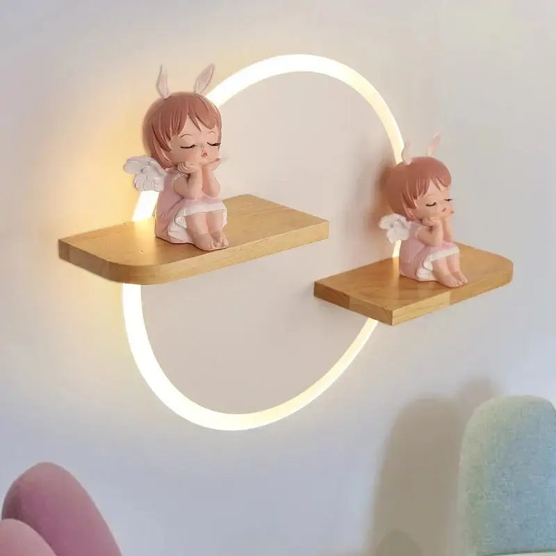 Cute pink angel figurines with bunny ears and wings on wooden shelf of decorbites led wall lamp for bedroom