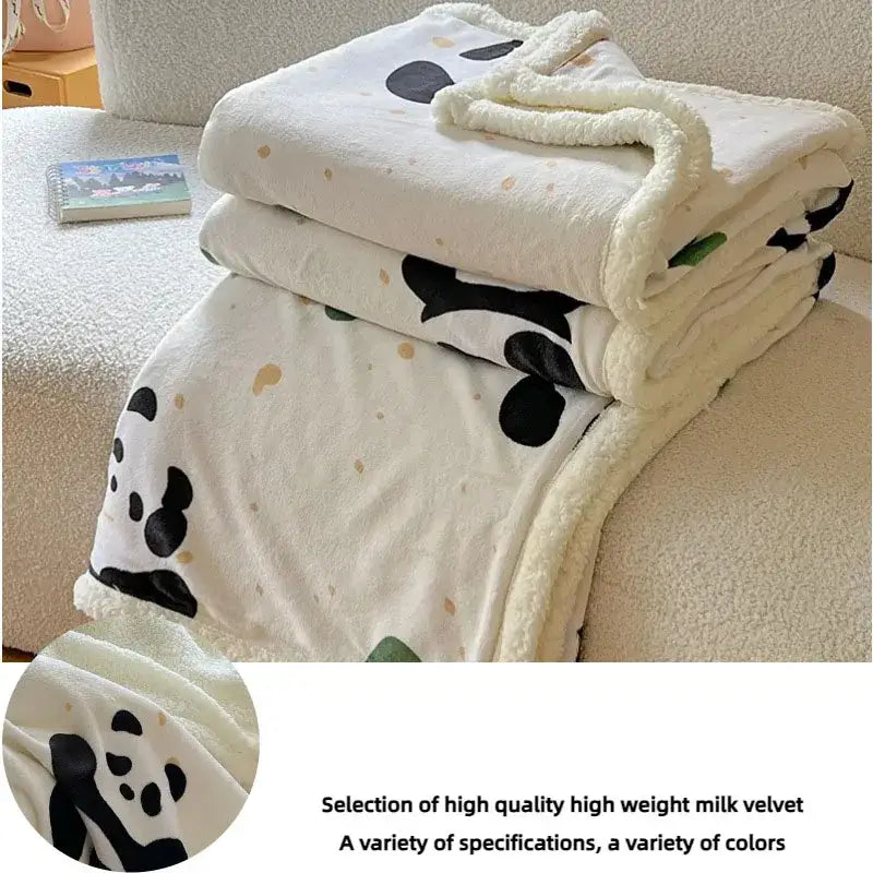 White cartoon lamb wool blanket with black panda faces, light brown speckles, and soft fleece border for bedroom use