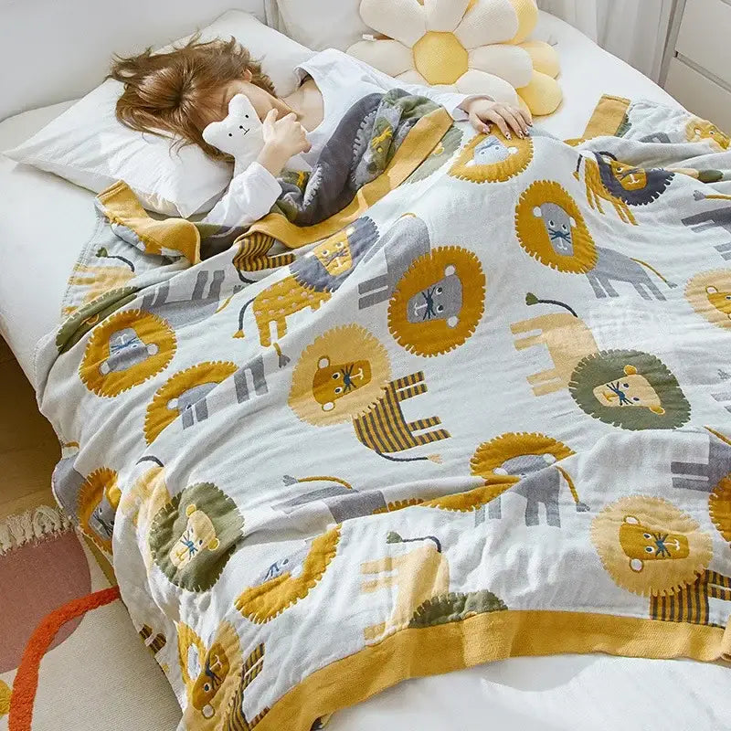 A soft white cartoon lion cotton throw blanket with yellow and gray lion decor and a mustard yellow trim for bedroom decorbites