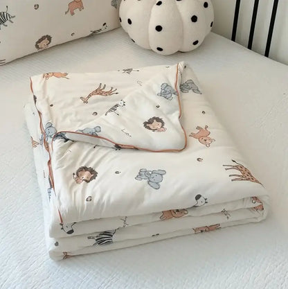 A cream-colored cartoon patchwork summer blanket with playful pastel giraffes lions and elephants for bedroom comfort