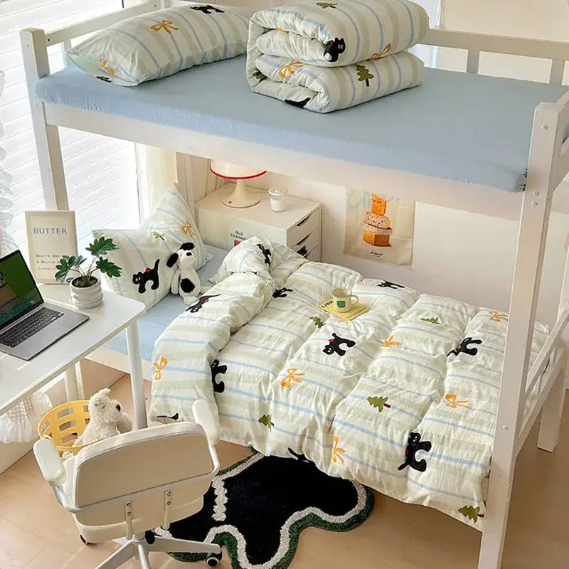 White bunk bed with light blue mattress toppers and decorbites cartoon printed bedding sets featuring black cat and yellow bow patterns