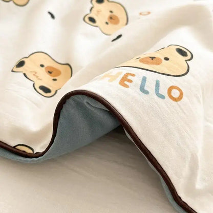 A soft white cooling blanket with beige cartoon bear faces hello print and brown stitched edge decorbites cartoon printed summer