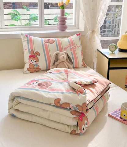Pastel pink and cream striped cooling blanket with decorbites cartoon printed bunnies in red bows for summer use