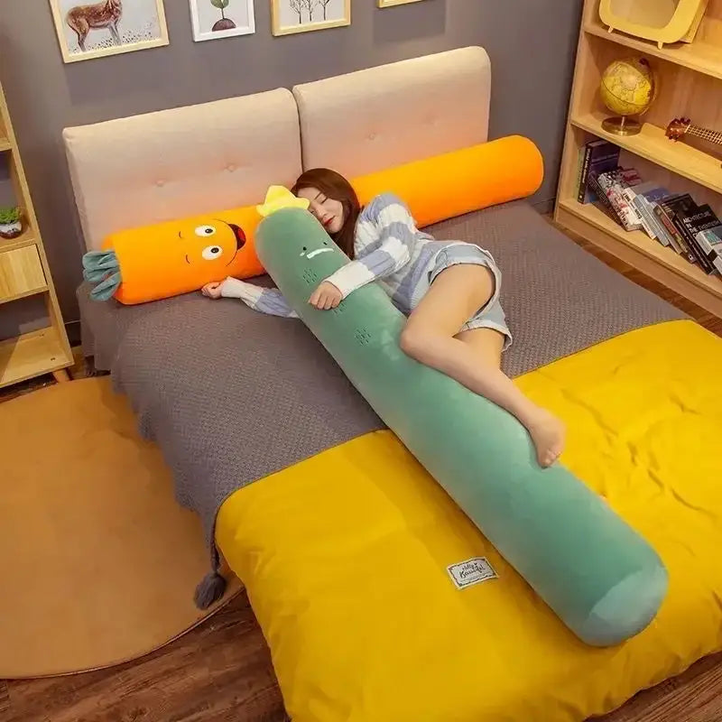 A plush long body pillow in green and orange with embroidered face for decorbites comfort long bedroom decor