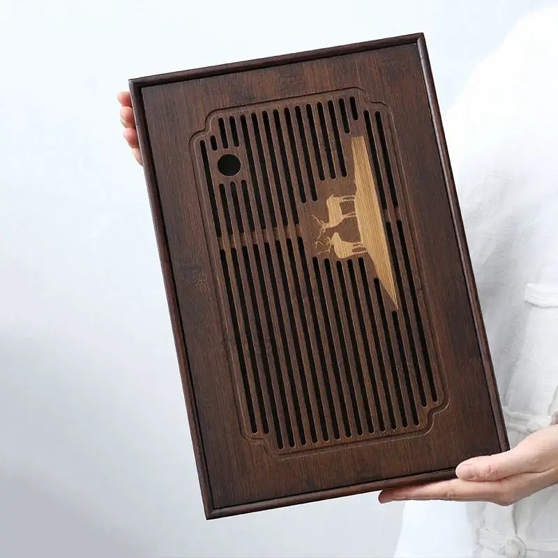 Dark brown bamboo tea tray with vertical slats and carved golden deer for dining room drainage board use