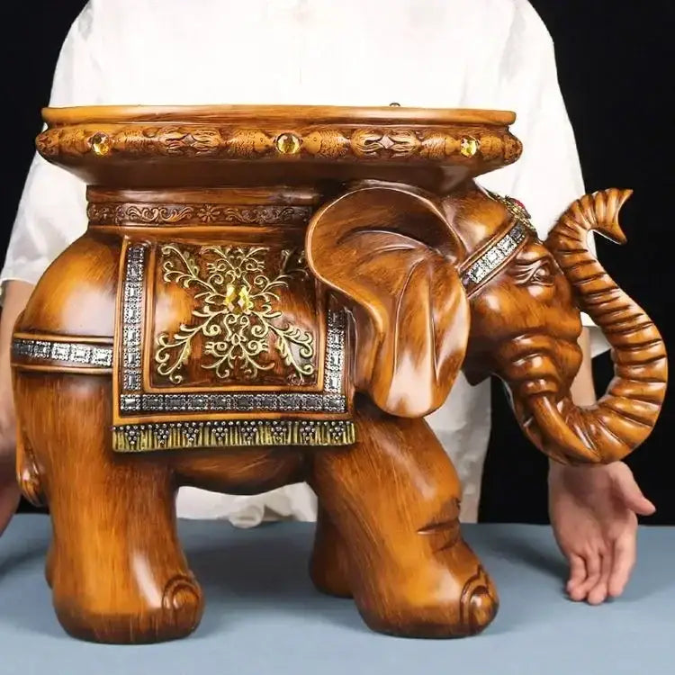 Carved wood elephant wealth attracting stool with ornate gold and silver inlay and polished brown finish on its back