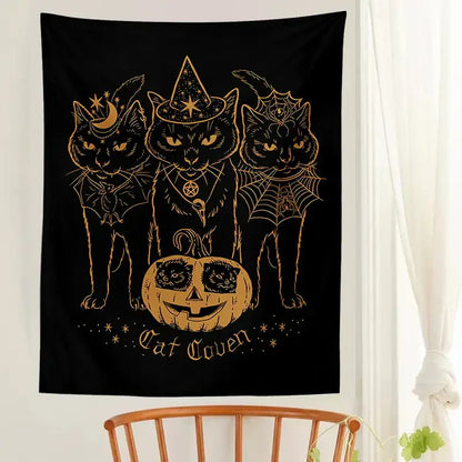 Black tapestry featuring three stylized black cats with gold foil details and a carved pumpkin for cat coven witchcraft decorbites cat coven wall art