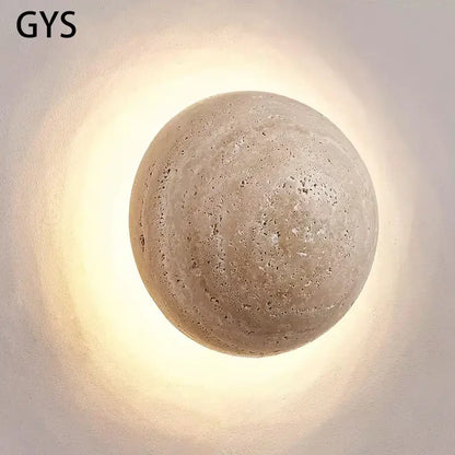 Beige textured stone sphere wall lamp with warm diffused glow for bedroom ambiance by decorbites cave stone yellow