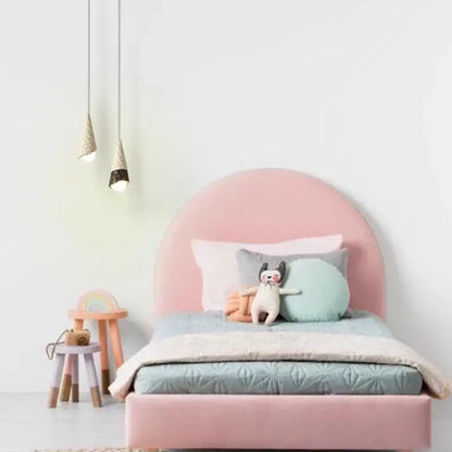 Pink upholstered bed with curved headboard and footboard shown alongside white and black ceramic ice cream pendant light with led bulb
