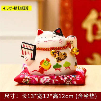 White ceramic maneki neko piggy bank with black ears red accents and gold coins for living room decor by decorbites ceramic maneki