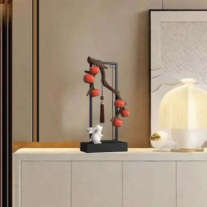 Ceramic home decor set with a white rabbit under a black metal frame featuring red persimmon for living room display