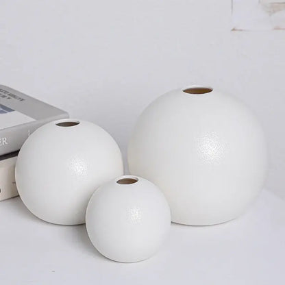 Set of three minimalist ceramic round vases black white with smooth glossy finishes and uniform circular openings