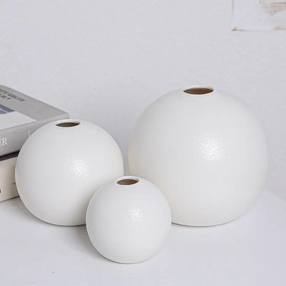 Set of three white ceramic round vases with matte finish and uniform circular openings from vase black white collection
