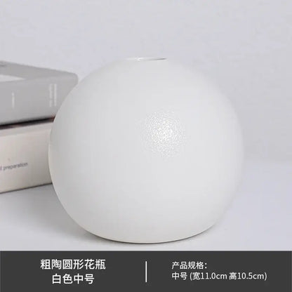 A white ceramic round vase black white with a slightly textured surface and a narrow opening at the top
