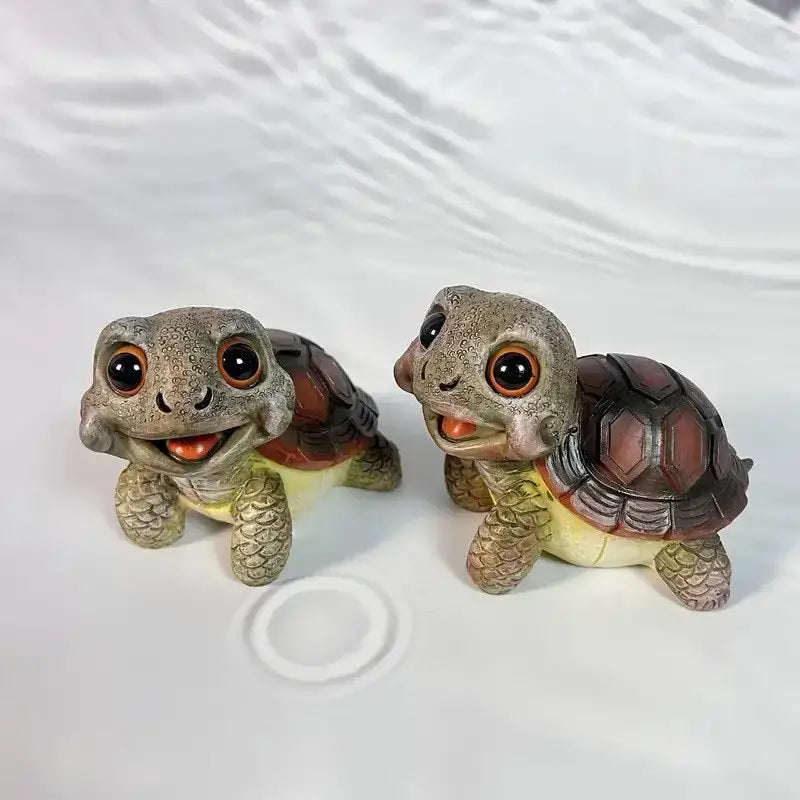 Two adorable crawling turtle sculptures with detailed gray and brown shells and expressive orange eyes for garden decorbites decor