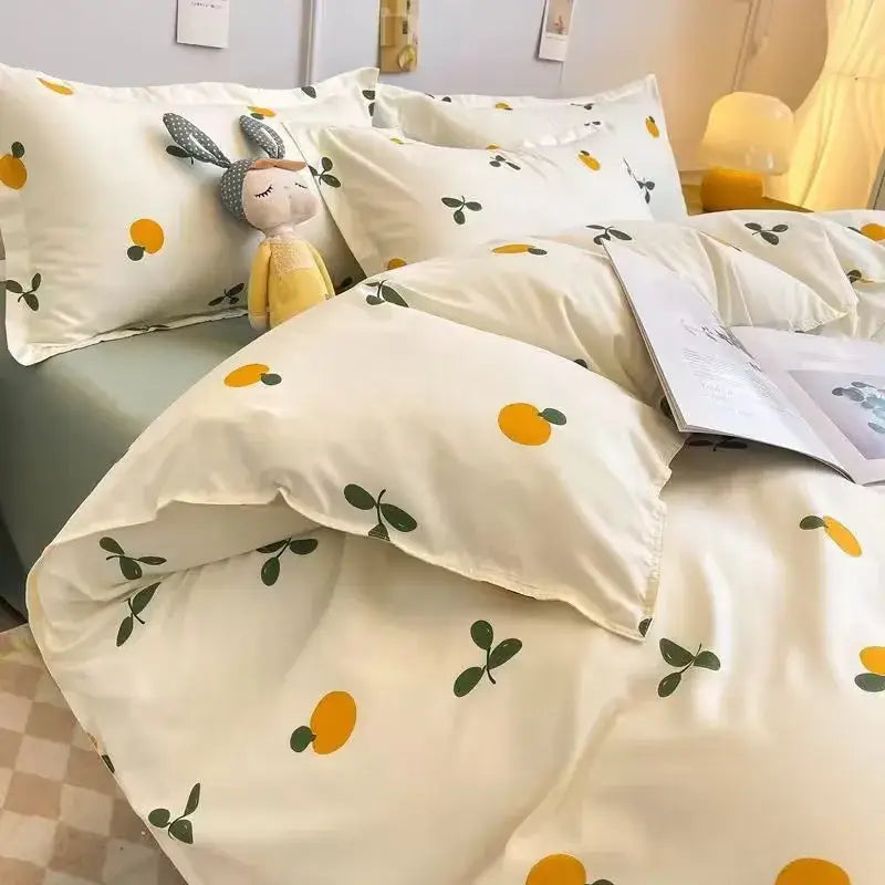 Cream-colored satin duvet cover set with bright yellow citrus fruit and dark green leaf pattern for bedroom use