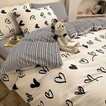 White cotton duvet cover set with black heart patterns and matching pillowcases in checkerboard black and beige satin design