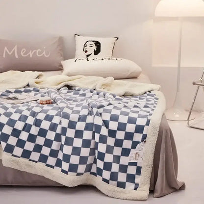 Blue and white checkered fleece blanket with a soft, plush texture.