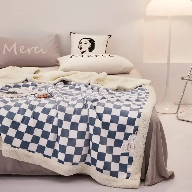 Blue and white checkered fleece blanket with a soft, plush texture.