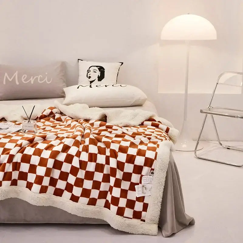 A cozy orange and white checkerboard lamb fleece blanket with soft cream fleece lining for decorbites checkerboard lamb decor