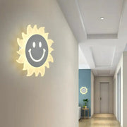 Cheerful white smiling sun led wall sconce glowing with illuminated face design for bedroom lighting