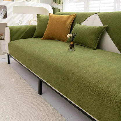 Olive green chenille textured non slip sofa cover with herringbone pattern white trim and black metal legs for living room sofa cushion
