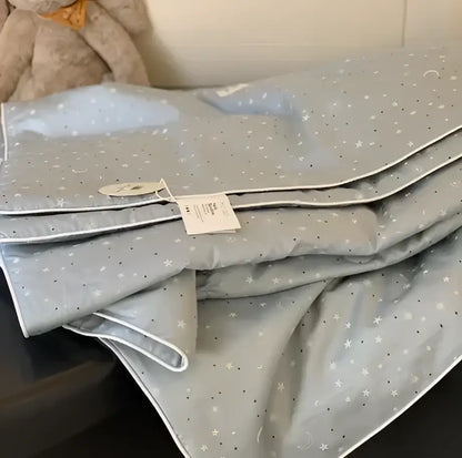 Gray star-patterned cooling quilt with white stitching and plush texture for a comfortable night’s sleep by decorbites