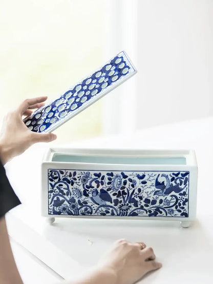 Blue and white ceramic tissue box with intricate floral and bird patterns in white porcelain decorbites blue white style