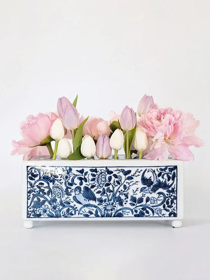 A rectangular white porcelain flowerpot vase with blue and white floral bird pattern holding pink tulips and peonies decorbites blue white