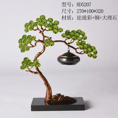 Chinese style gold enamel pine ornaments featuring a copper-toned bonsai tree sculpture with green leaves and incense burner