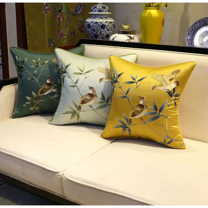 Three embroidered satin pillow covers in green light blue and yellow with birds branches decorbites birds branches motifs