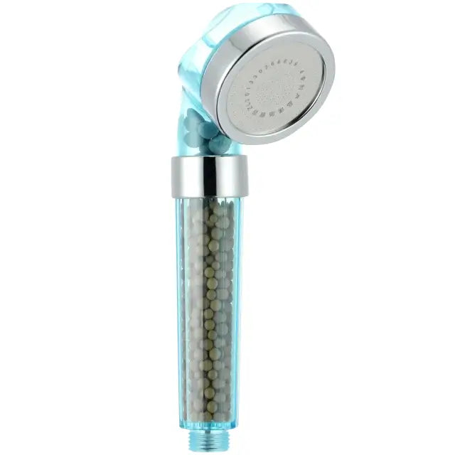 Light blue transparent decorbites anion spa shower head with silver metallic nozzle and greenish beads inside filter housing