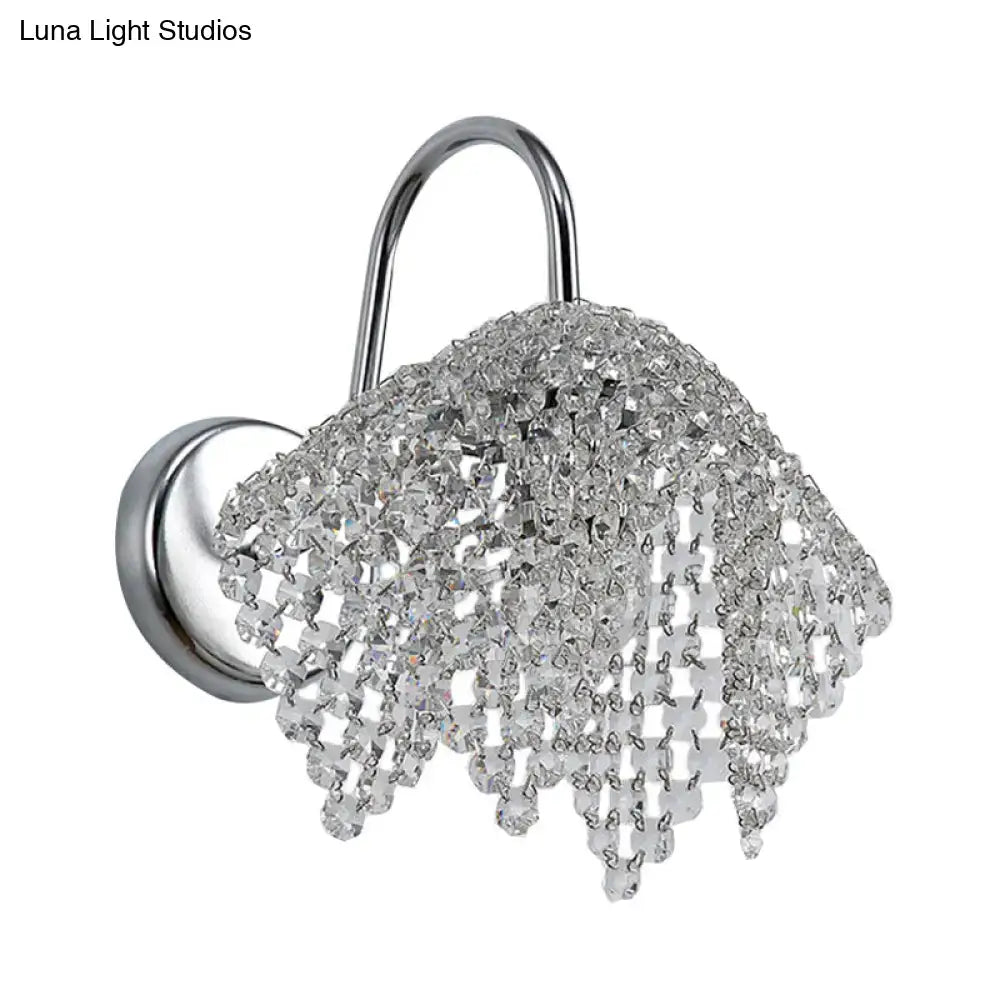 A chrome crystal drip wall sconce light wall mount with cascading clear crystal beads for bedroom use
