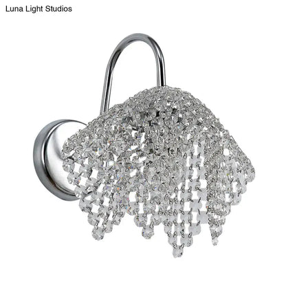 A chrome crystal drip wall sconce light wall mount with cascading clear crystal beads for bedroom use